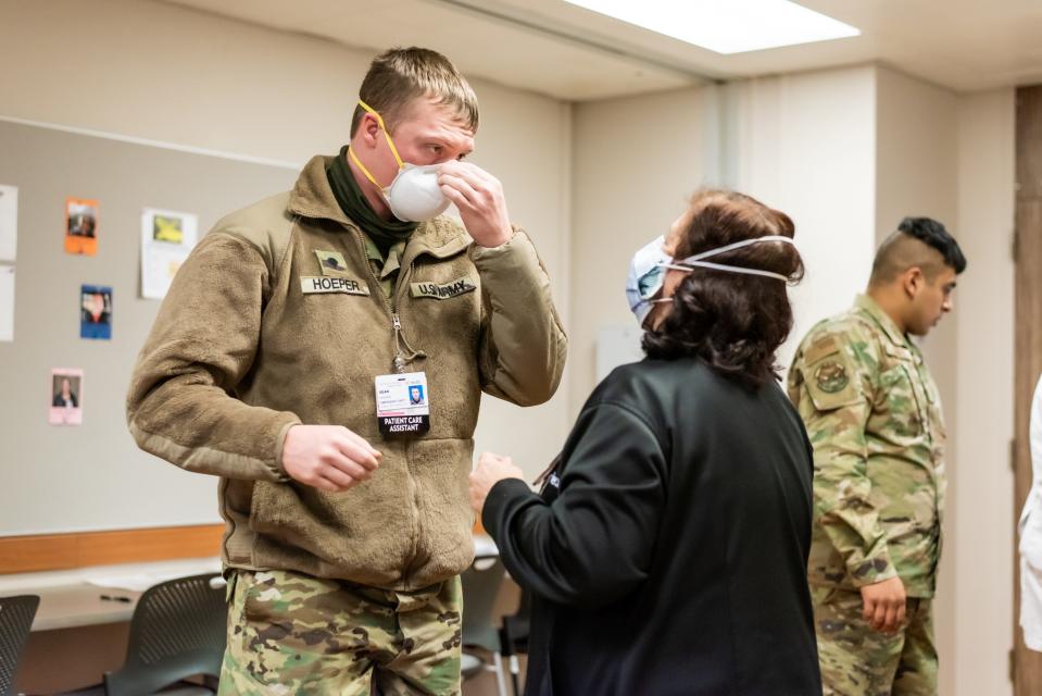 An Ohio National Guard member talks with a University of Cincinnati Medical Center staff member on Monday, Jan. 24, 2022. Another 70 troops arrived to assist UC Health staff during the omicron-fueled surge of COVID-19 cases. They did PPE (personal protective equipment) fit-testing and had orientation on Monday.