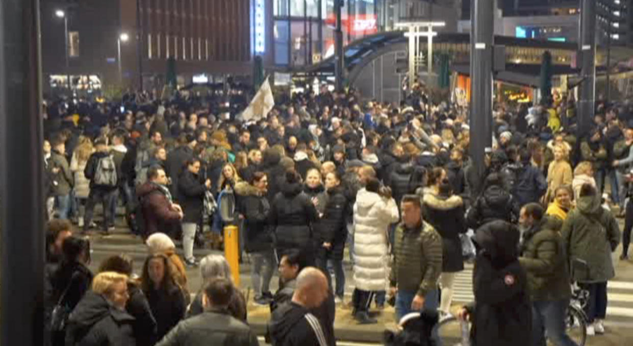 In this image taken from video, demonstrators protest against government restrictions due to the coronavirus pandemic, Friday, Nov. 19, 2021, in Rotterdam, Netherlands. Police fired warning shots, injuring an unknown number of people, as riots broke out Friday night in downtown Rotterdam at a demonstration against plans by the government to restrict access for unvaccinated people to some venues. (Media TV Rotterdam via AP)