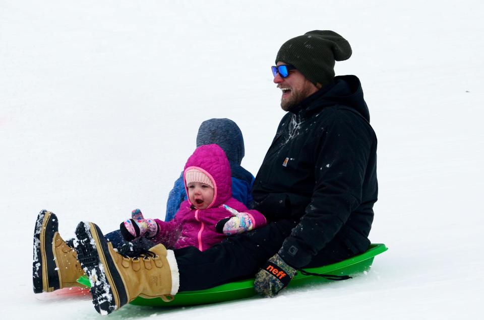 Visiting from Cincinnati, Drake, Gigi and Hazen Perry sled together on Wednesday, Dec. 28, 2022 at the Winter Sports Park in Petoskey.
