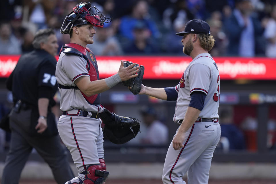 Atlanta Braves catcher Sean Murphy, left, celebrates with relief pitcher A.J. Minter after the first baseball game of a doubleheader against the New York Mets at Citi Field, Monday, May 1, 2023, in New York. (AP Photo/Seth Wenig)