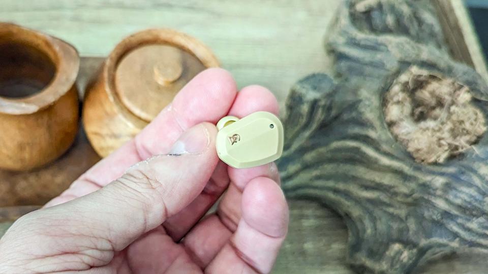 Campfire Audio Orbit earbuds held between reviewer's fingertips