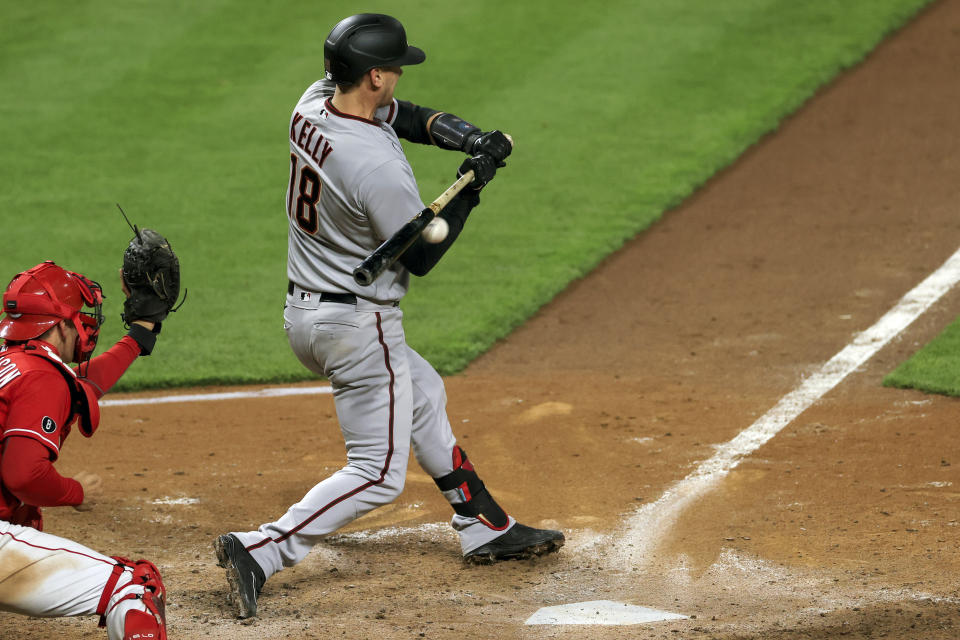 Arizona Diamondbacks' Carson Kelly reacts as he is hit by a pitch for an RBI during the tenth inning of a baseball game against the Cincinnati Reds, Wednesday, April 21, 2021. The Diamondbacks won 8-5. (AP Photo/Aaron Doster)