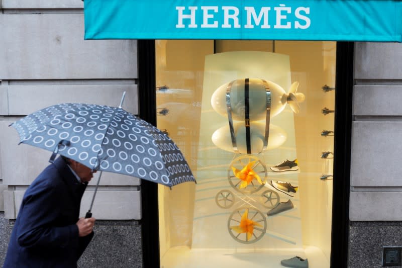 A pedestrian walks past the Hermes store in Boston, Massachusetts, U.S., April 26, 2017. REUTERS/Brian Snyder