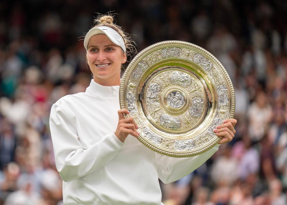 Marketa Vondrousova poses with her trophy after winning the 2023 Wimbledon women's singles title.