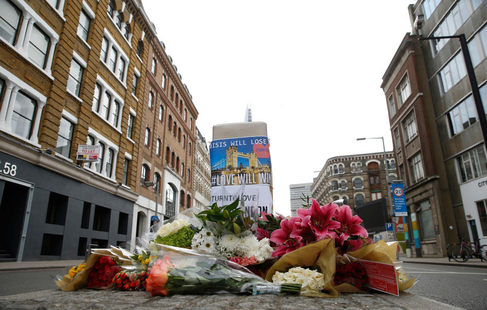 <p>Floral tributes line the pavement in an area in the London Bridge area of London, Monday, June 5, 2017. (Photo: Alastair Grant/AP) </p>