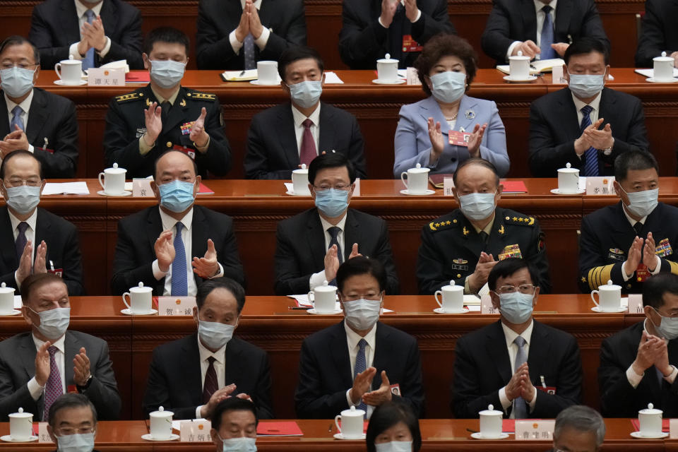 'Delegates applaud as Chinese President Xi Jinping delivers a speech at the closing ceremony for China's National People's Congress (NPC) at the Great Hall of the People in Beijing, Monday, March 13, 2023. (AP Photo/Andy Wong)