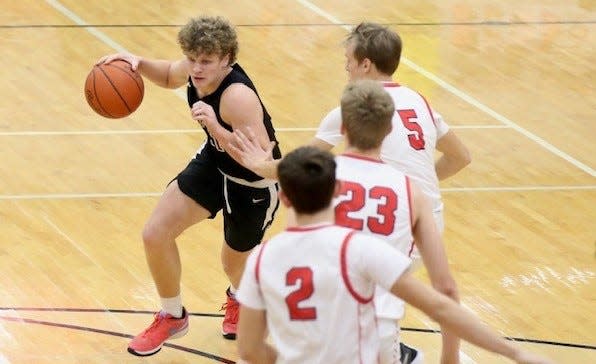 New Boston Huron's Nate Morse drives against Milan Tuesday night.