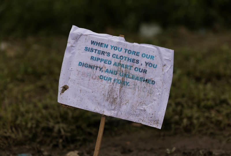 A placard is pictured at the site of a protest against the alleged sexual assault of two tribal women, in Churachandpur district