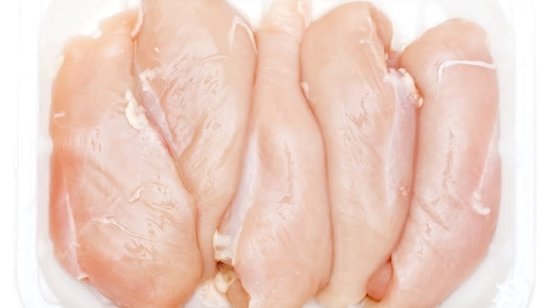 Raw chicken breasts in packaging 
