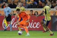 Houston Dynamo forward Corey Baird, left front, moves the ball in front of Real Salt Lake defender Bryan Oviedo, back left, and Real Salt Lake midfielder Nelson Palacio during the first half of an MLS playoff soccer match Saturday, Nov. 11, 2023, in Houston. (AP Photo/Michael Wyke)