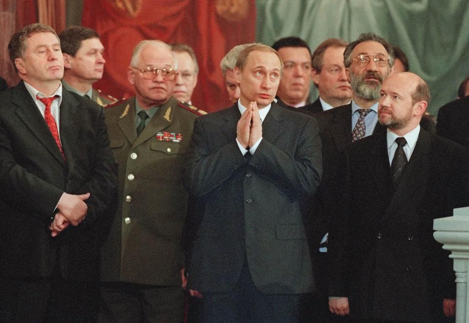 FILE - Vladimir Putin, center, attends a Christmas service in Christ the Savior Cathedral in Moscow, Jan. 8, 2000. Since coming to power almost 25 years ago, Putin has eliminated nearly all independent media and opposition voices in Russia — a process he ramped up after the 2022 invasion of Ukraine. (AP Photo/Misha Japaridze, File)