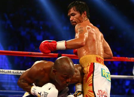 April 9, 2016; Las Vegas, NV, USA; Manny Pacquiao throws a punch as Timothy Bradley defends at MGM Grand Garden Arena. Mark J. Rebilas-USA TODAY Sports