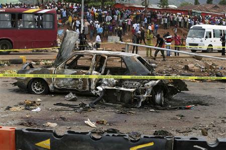 A damaged car is seen at the scene of a car bomb blast in Nyanya, Abuja, May 2, 2014. REUTERS/Afolabi Sotunde