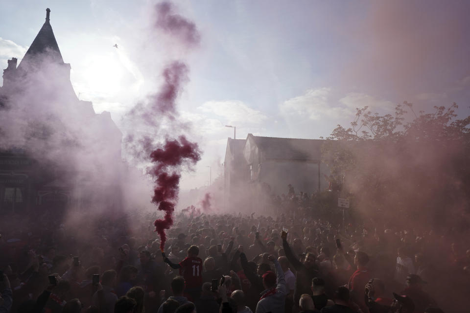 Liverpool fans let off flares ahead of the Champions League semi final, first leg soccer match between Liverpool and Villarreal at Anfield stadium in Liverpool, England, Wednesday, April 27, 2022. (AP Photo/Jon Super)