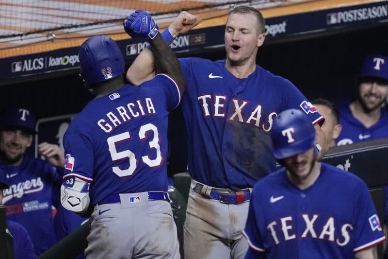 Texas Rangers outfielder Adolis Garcia celebrates with Josh Jung after hitting a solo home run in the eighth inning against the Houston Astros in Game 7 of the ALCS on Monday at Minute Maid Park in Houston. Photo by Kevin M. Cox/UPI