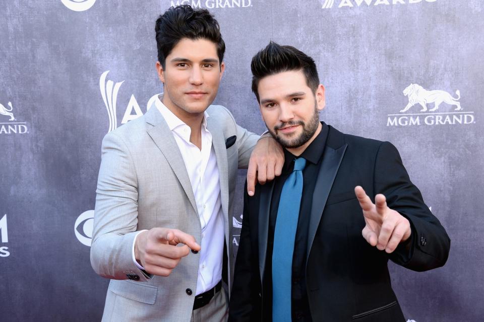 <p>Duo of the year nominees Dan Smyers and Shay Mooney of Dan + Shay had fun on the 2014 carpet, posing alongside each other and showing off their own unique styles in different colored suits. </p>