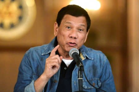 FILE PHOTO: Philippine President Rodrigo Duterte announces the disbandment of police operations against illegal drugs at the Malacanang palace in Manila, Philippines early January 30, 2017.     REUTERS/Ezra Acayan/File Photo