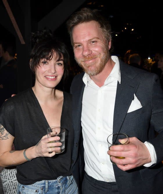 Lena Headey and Marc Menchaca smiling and holding glasses