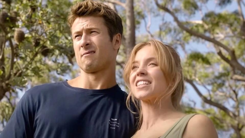Glen Powell making a face next to Sydney Sweeney
