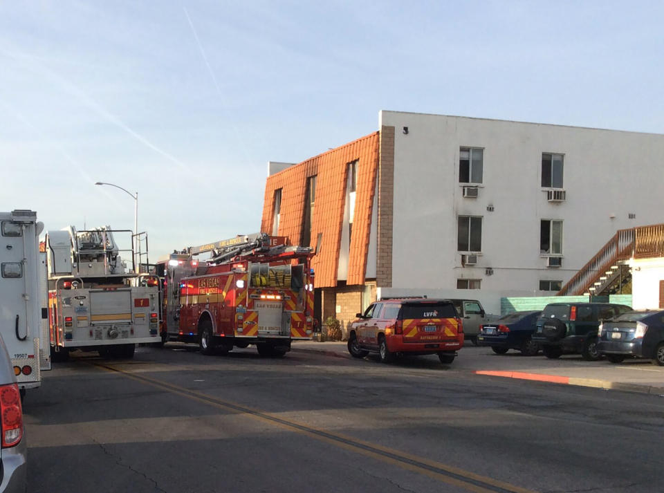 This photo provided by the Las Vegas Fire Department, firefighters work the scene of a fire at a three-story apartment complex early Saturday, Dec. 21, 2019 in Las Vegas. The fire was in first-floor unit of the Alpine Motel Apartments and its cause was under investigation, the department said. Authorities say multiple fatalities were reported and several were injured. (Las Vegas Fire Department via AP)