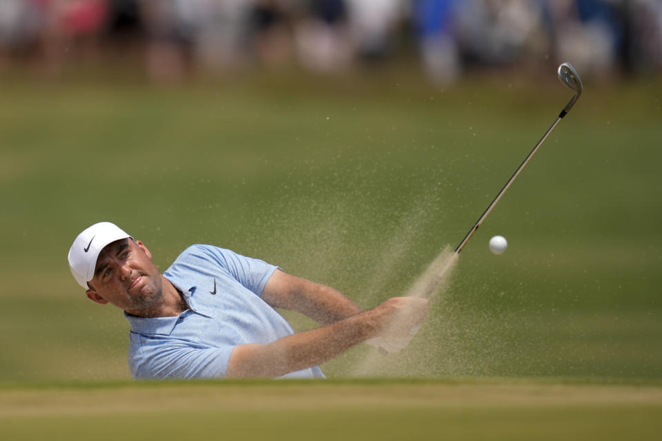 Scottie Scheffler hits from the bunker on the 10th hole during the third round of the U.S. Open golf tournament Saturday, June 15, 2024, in Pinehurst, N.C. (AP Photo/Mike Stewart)