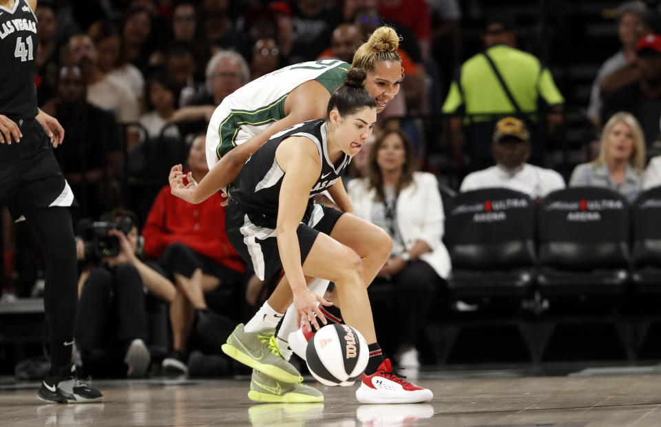 Las Vegas Aces guard Kelsey Plum, front,steals the ball from Seattle Storm center Mercedes Russell (21) during the first half of a WNBA basketball game in Las Vegas on Friday, June 7, 2024. (Steve Marcus/Las Vegas Sun via AP)