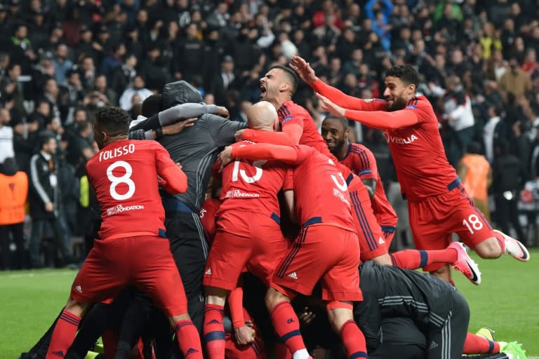 Lyon's players celebrate their victory at the end of the UEFA Europa League second leg quarter final football match against Besiktas April 20, 2017