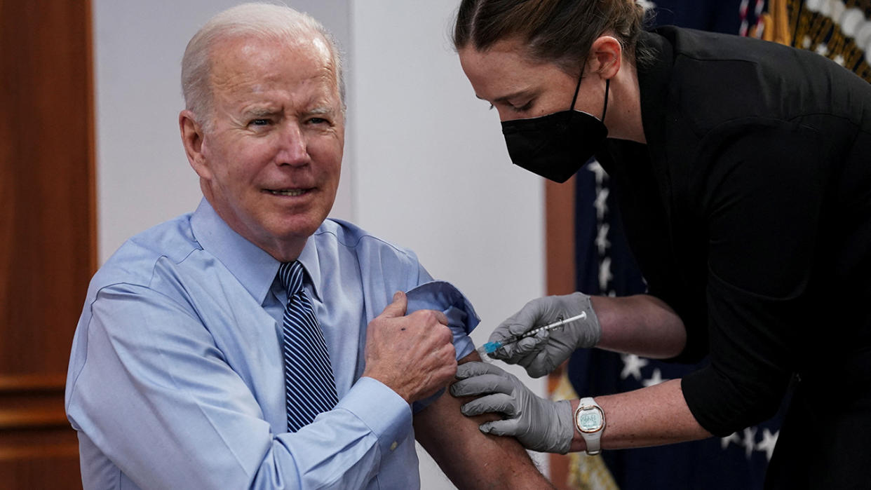 President Biden receives his second COVID-19 booster vaccination after delivering remarks on the pandemic at the White House on Wednesday. 