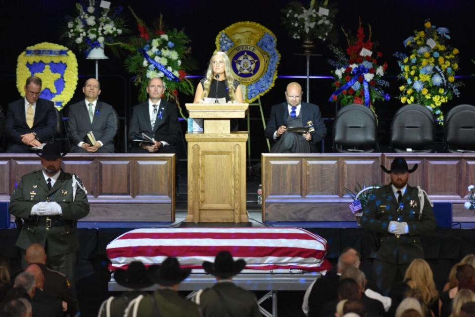  Santaquin Sgt. Bill Hooser’s daughter, Shayle Terry, speaks during his funeral at the Utah Valley University’s UCCO Event Center on Monday, May 13, 2024. (Kyle Dunphey/Utah News Dispatch)