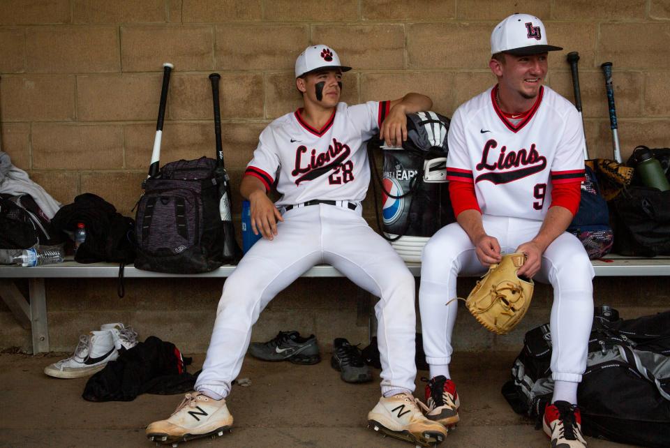 Jacob Miller sits on the bench inside of the dugout hanging out with friend and Liberty Union catcher senior Austin Ety before he takes to the pitchers mound to pitch against Cardington in a Division III baseball game at Liberty Union High School in Baltimore, Ohio on May 11, 2022. Austin has been playing baseball with Jacob since they were in little league baseball together.