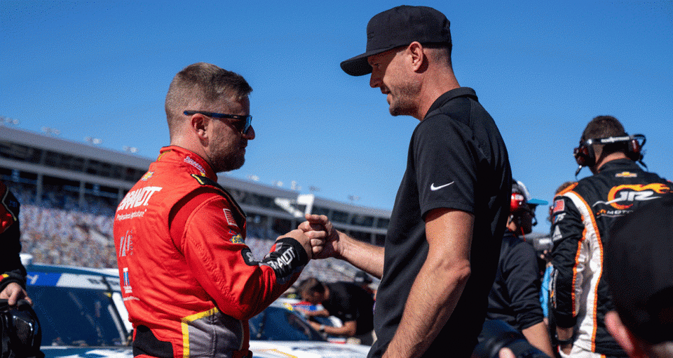 Josh Wise fist-bumps Justin Allgaier on the grid at Charlotte Motor Speedway