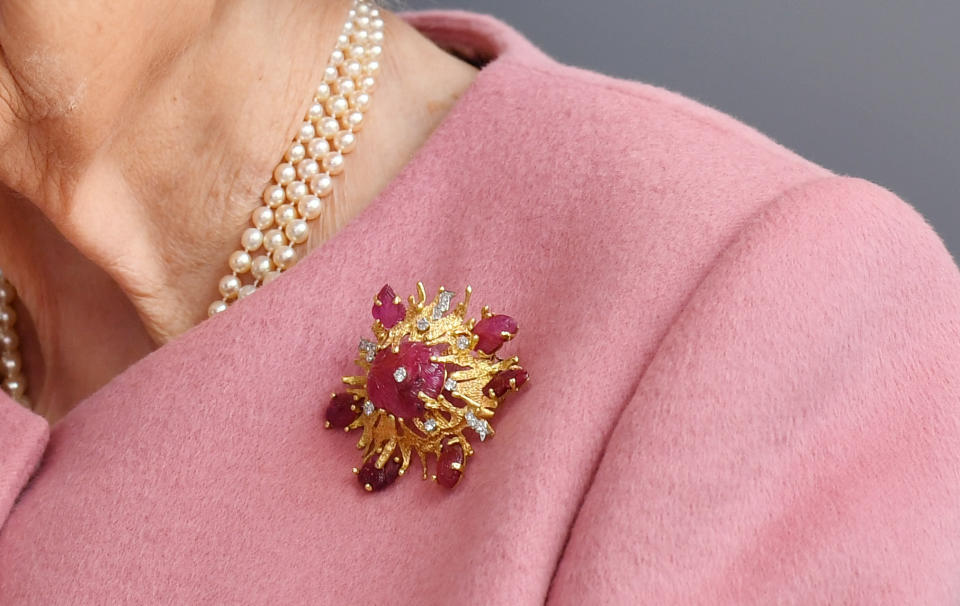 Details of the brooch worn by Queen Elizabeth II during a visit to the Energetics Analysis Centre at the Defence Science and Technology Laboratory (DSTL) at Porton Down, Wiltshire, to view a display of weaponry and tactics used in counter intelligence, and meet staff who were involved in the Salisbury Novichok incident. The brooch was a gift from the Duke of Edinburgh in 1966, for her visit to Porton Down.