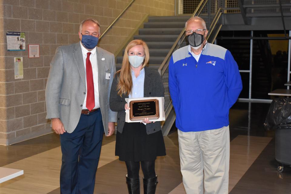 Madison High School's Megan Morgan was honored Dec. 13 as the Madison County Schools' District Teacher of the Year. She is pictured here alongside MHS Principal David Robinson, right, and Superintendent Will Hoffman.