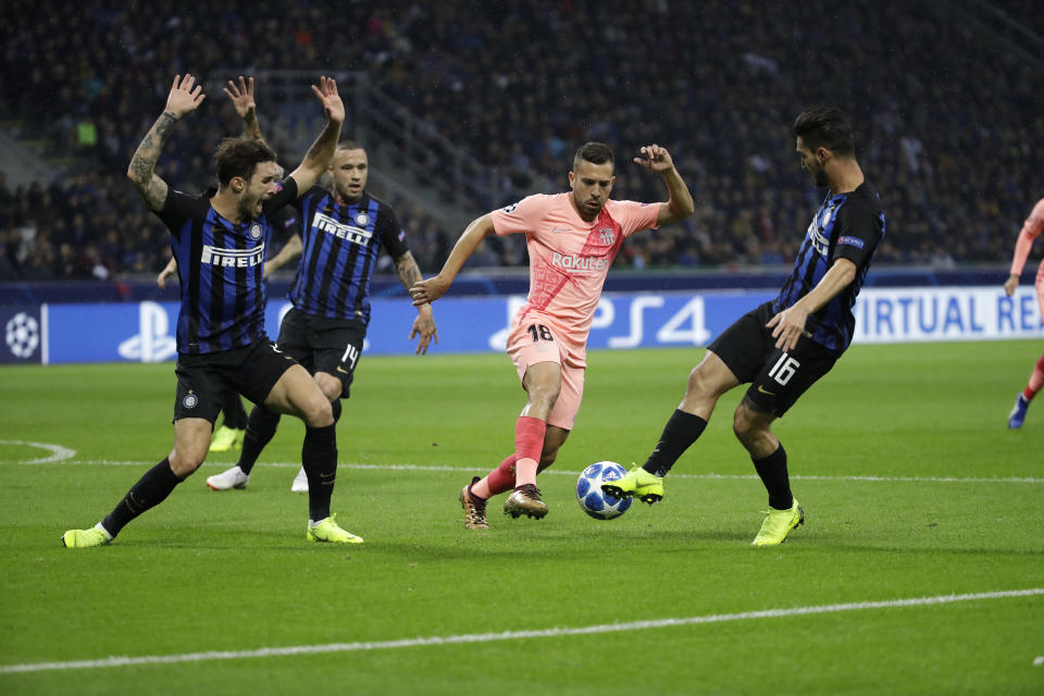 Barcelona defender Jordi Alba, second right, fights for the ball against Inter midfielder Matteo Politano, right, during the Champions League group B soccer match between Inter Milan and Barcelona at the San Siro stadium in Milan, Italy, Tuesday, Nov. 6, 2018. (AP Photo/Luca Bruno)