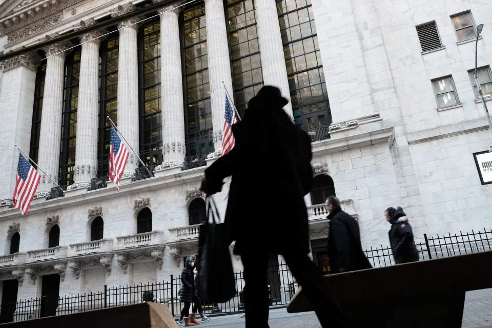 NEW YORK, NEW YORK - JANUARY 11: People walk by the New York Stock Exchange (NYSE) on January 11, 2022 in New York City. After yesterdays sell off, the Dow was down only slightly in morning trading. (Photo by Spencer Platt/Getty Images)