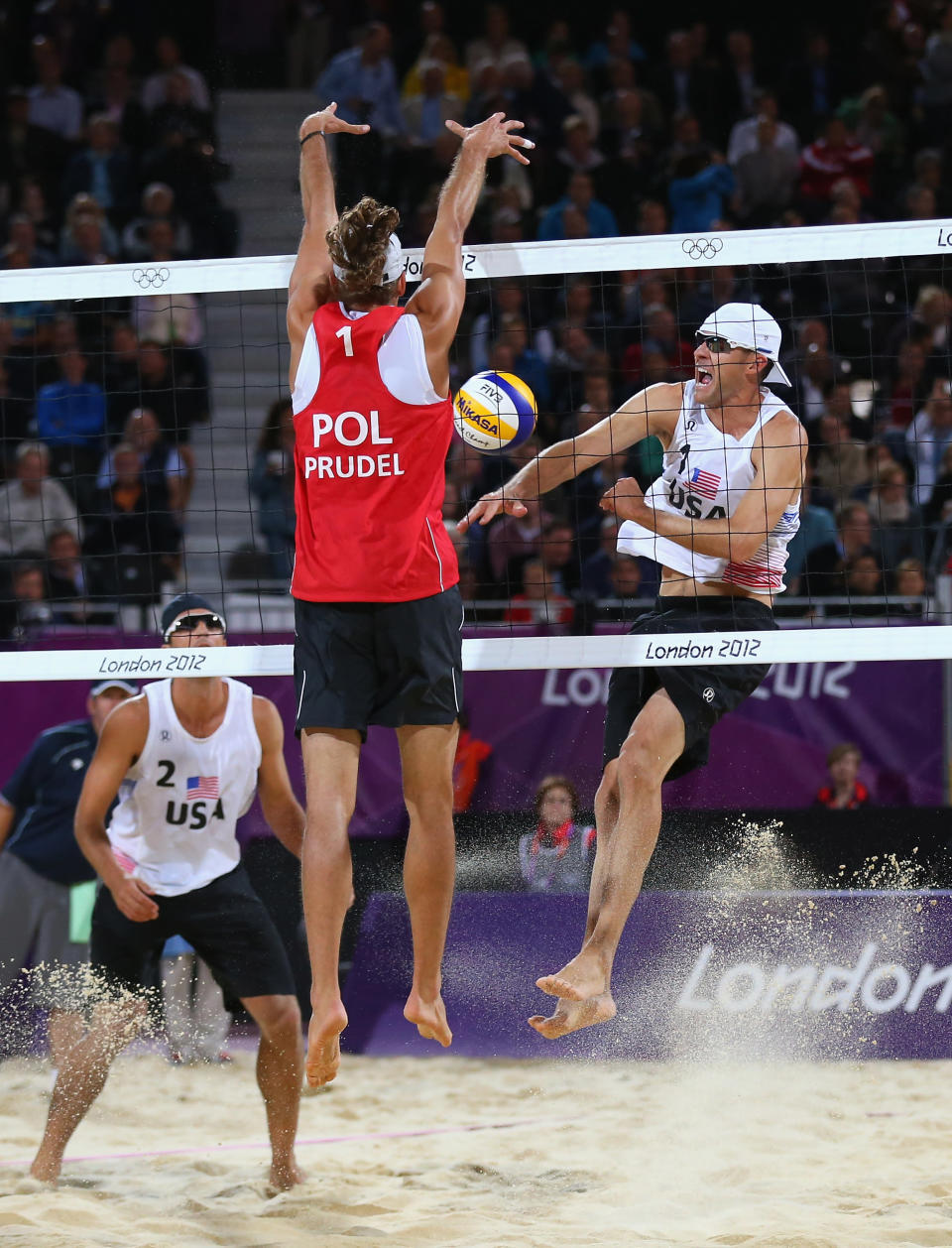 LONDON, ENGLAND - JULY 30: Mariusz Prudel of Poland blocks against Jacob Gibb of the United States during the Men's Beach Volleyball Preliminary match between United States and Poland on Day 3 of the London 2012 Olympic Games at Horse Guards Parade on July 30, 2012 in London, England. (Photo by Ryan Pierse/Getty Images)