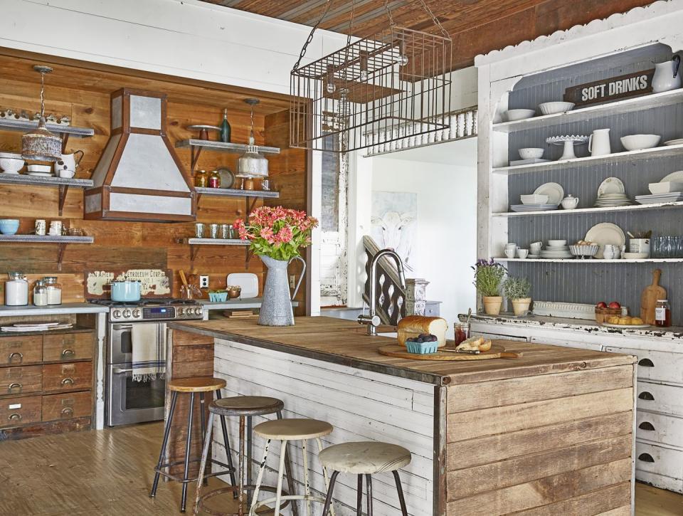 a rustic farmhouse kitchen with galvanized metal open shelves