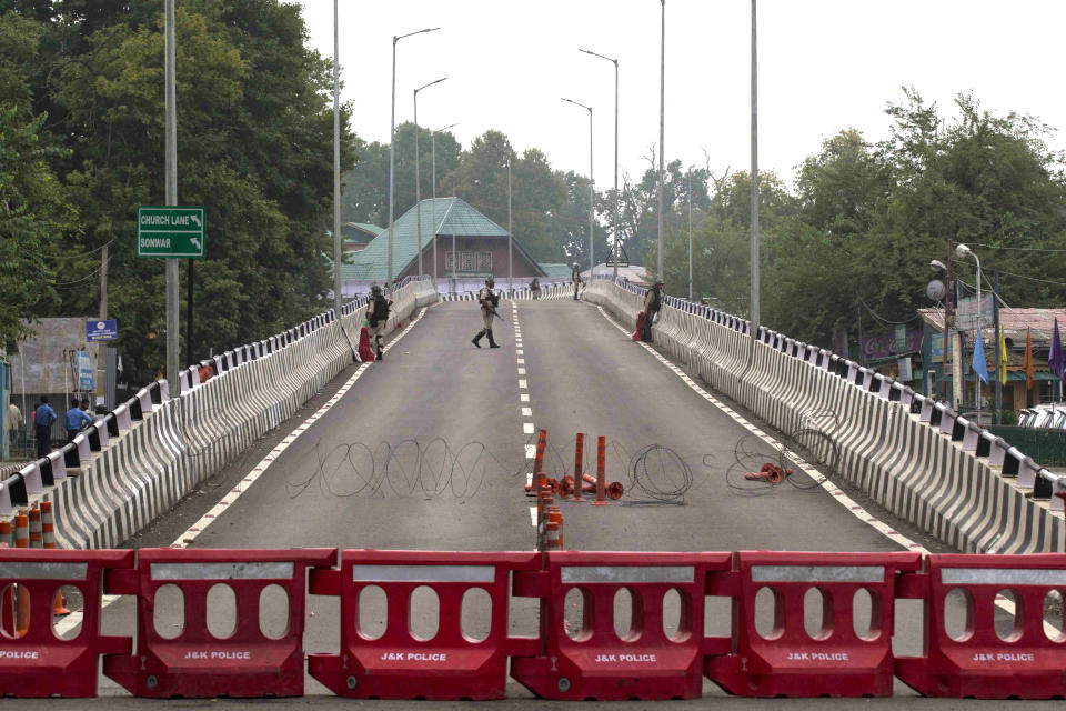 Indian paramilitary soldiers stand guard on a flyover during lockdown in Srinagar, Indian controlled Kashmir, Thursday, Aug. 15, 2019. Indian Prime Minister Narendra Modi says that stripping the disputed Kashmir region of its statehood and special constitutional provisions has helped unify the country. Modi gave the annual Independence Day address from the historic Red Fort in New Delhi as an unprecedented security lockdown kept people in Indian-administered Kashmir indoors for an eleventh day. (AP Photo/ Dar Yasin)