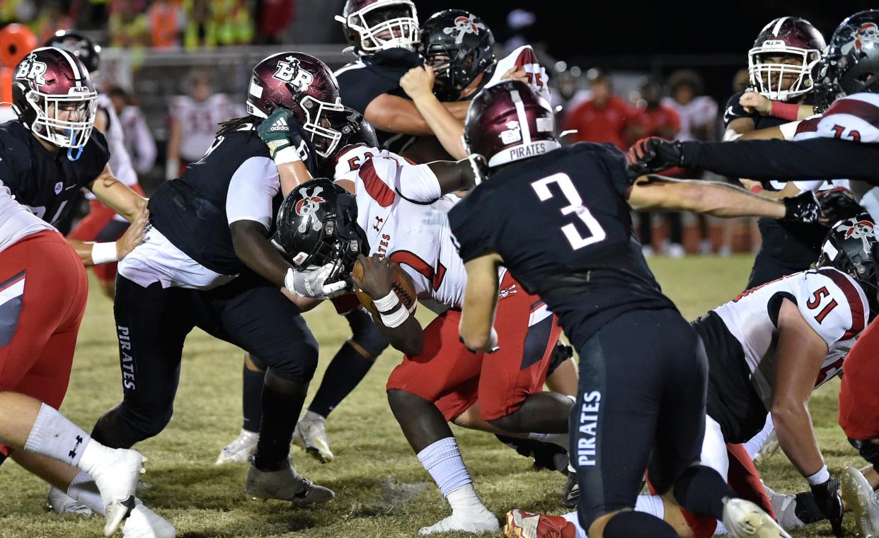 Port Charlotte Pirates' running back Edd Guerrier gets a few tough yards before being tackled down by the Braden River Pirates at the Pirates Stadium, Friday evening, Nov. 4, 2022, in east Bradenton.