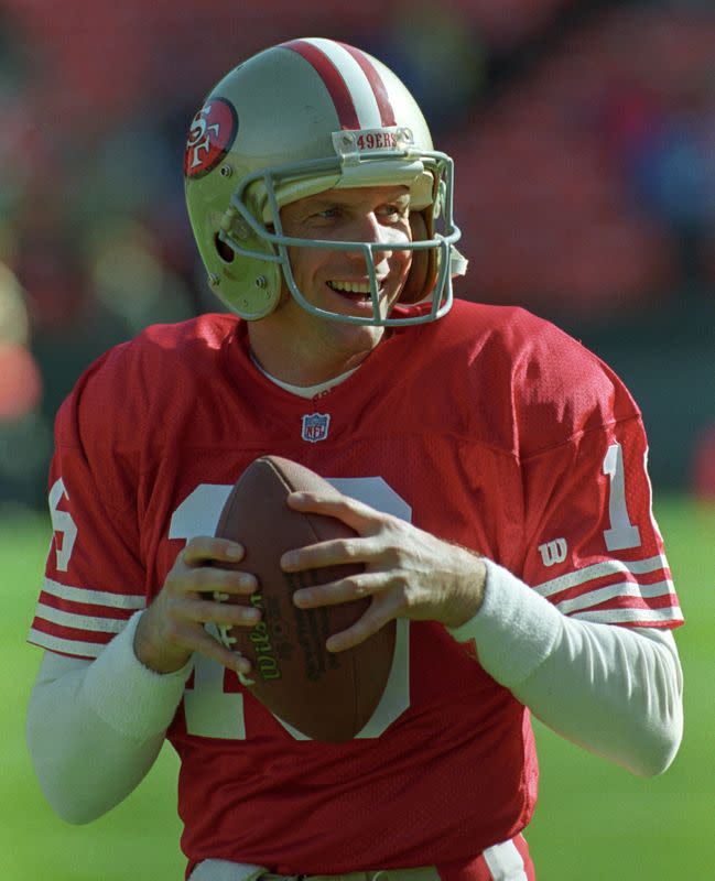FILE PHOTO: San Francisco 49ers quaterback Joe Montana smiles as he warms up for the first time in two seasons before the game against Tampa Bay at Candlestick Park