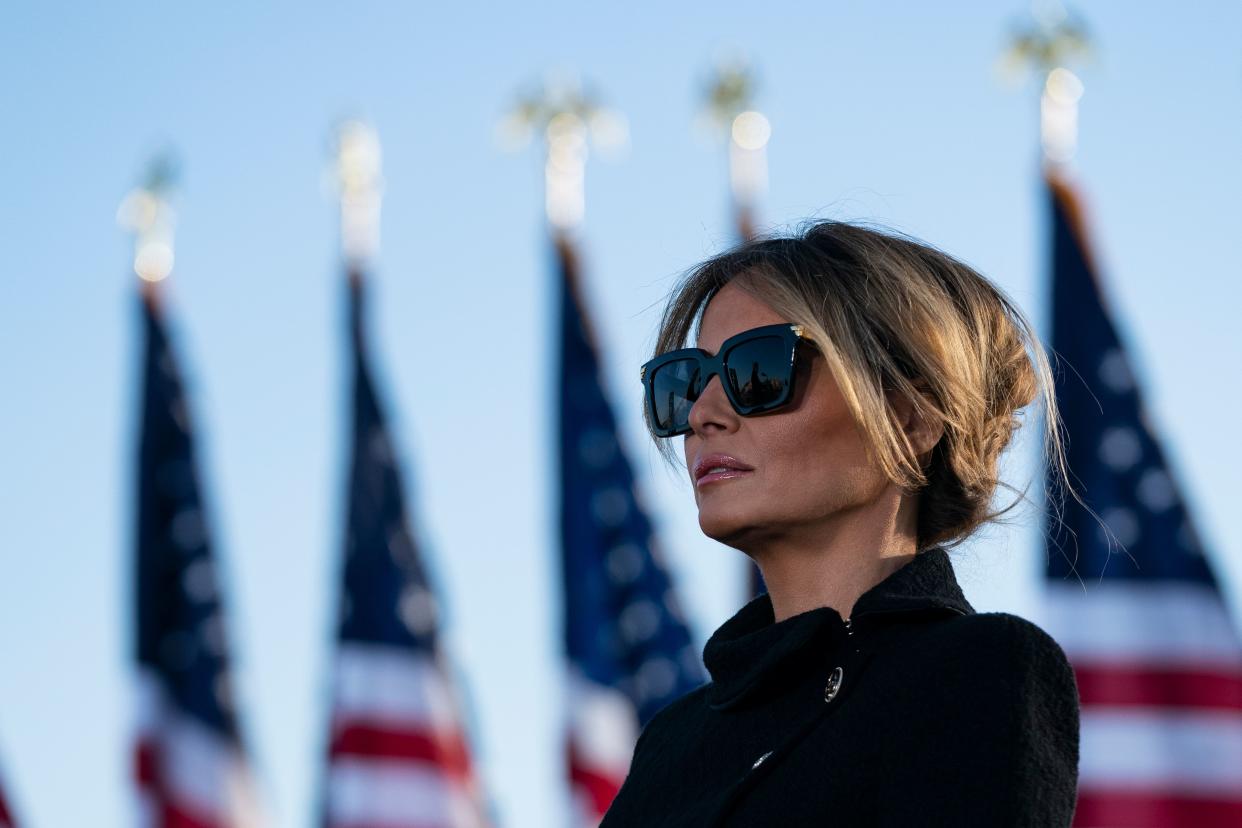 Outgoing First Lady Melania Trump listens as her husband Outgoing US President Donald Trump addresses guests at Joint Base Andrews in Maryland on January 20, 2021. (Getty Images)