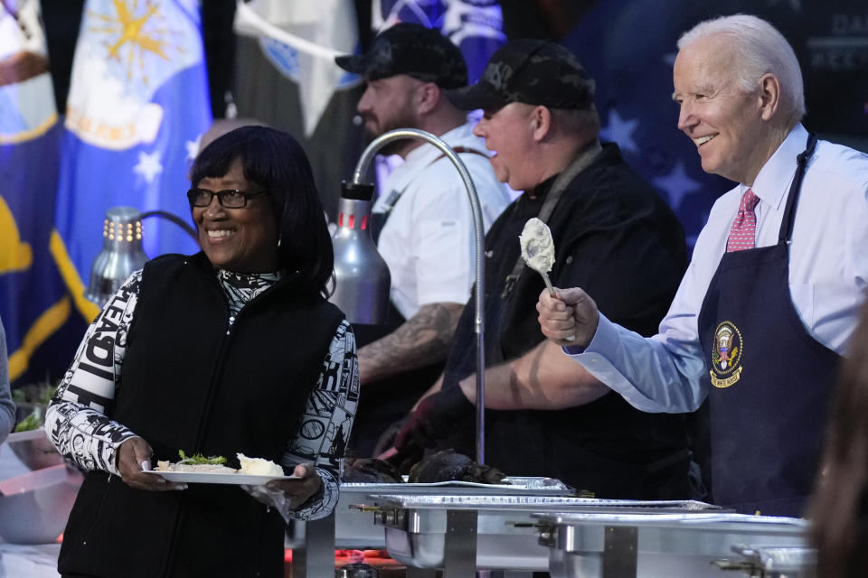 President Joe Biden poses for a photo as he helps serve a "friendsgiving" meal to service members and their relatives at the Norfolk Naval Station on Sunday, Nov. 19, 2023, in Norfolk, Va. (AP Photo/Manuel Balce Ceneta)