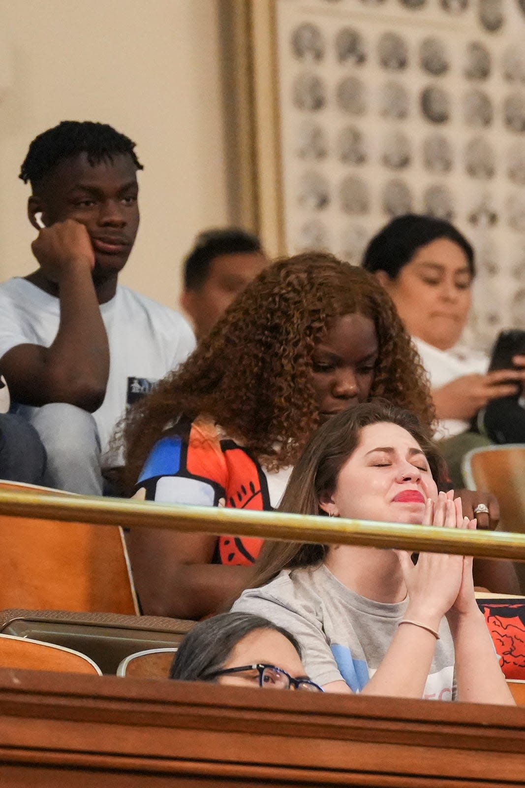 An LGBTQ+ activist reacts as Senate Bill 14 is debated in the Texas House on May 12. SB14 bans gender-affirming medical care for transgender children.