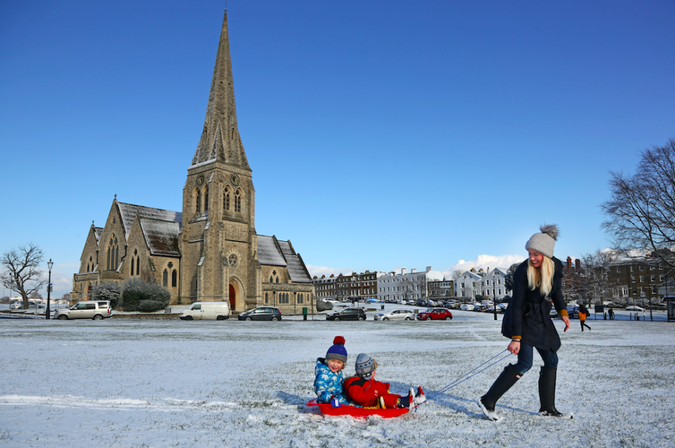 <em>Children like these youngsters in Blackheath, London, are experiencing a much more enjoyable day as hundreds of schools remain closed (Rex)</em>