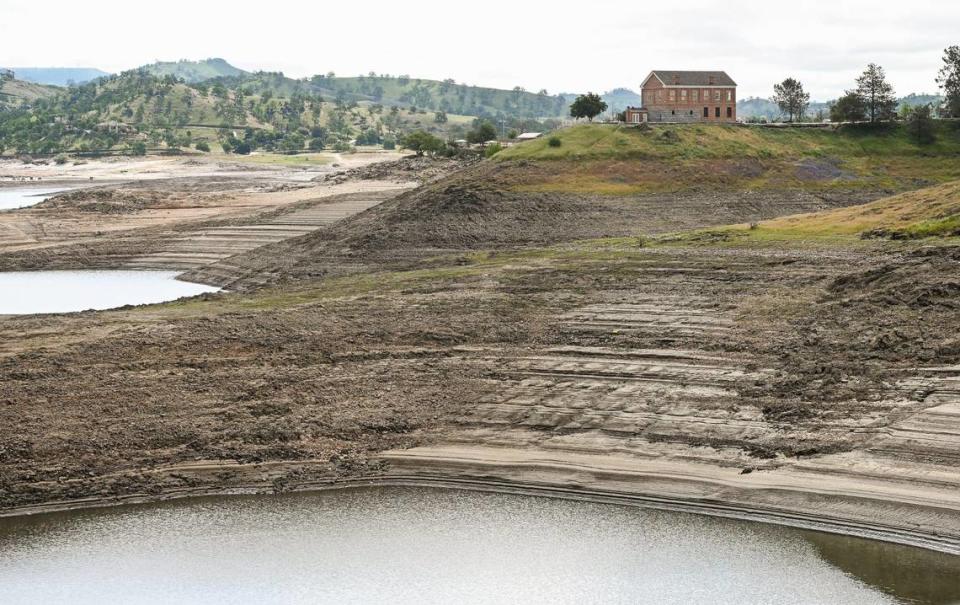 The old Millerton Courthouse sits above Millerton Lake which continues to fill while releases from Friant Dam are in excess of 8,000 cubic feet per second to make room in the lake on Tuesday, April 11, 2023. Officials are expecting the massive snowpack will eventually cause the lake to reach a level where water will pour over the spillway.