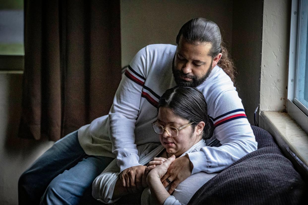 Nelson Torres Sr. hugs his wife Raysa inside their rental home in Palm Springs where they have been raising their four children, ages 11 to 17. Their family, which has multiple family members with severe medical needs, is facing eviction by the end of the month.