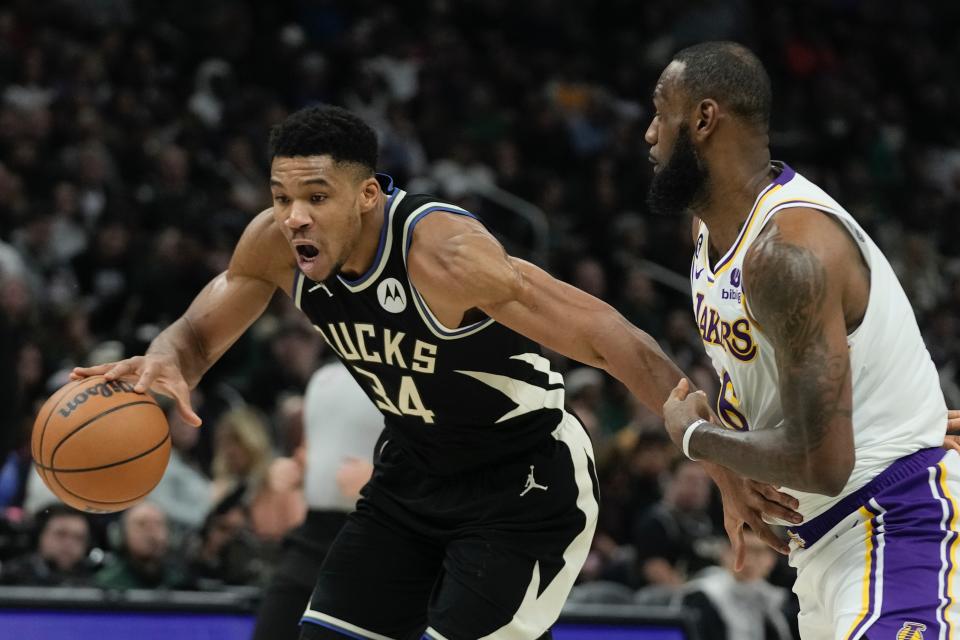 Milwaukee Bucks' Giannis Antetokounmpo drives past Los Angeles Lakers' LeBron James during the first half of an NBA basketball game Friday, Dec. 2, 2022, in Milwaukee. (AP Photo/Morry Gash)