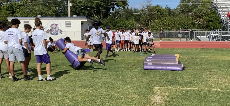 De’Vondre Campbell coaches kids through football drills at his annual youth camp at Cypress Lake High School on April 30, 2022