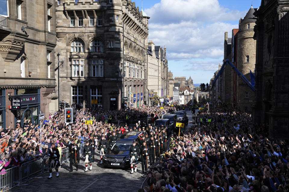 The Procession of Queen Elizabeth's coffin from the Palace of Holyroodhouse to St Giles Cathedral moves along the Royal Mile in Edinburgh, Scotland, Monday, Sept. 12, 2022. At the Cathedral there will be a Service to celebrate the life of The Queen and her connection to Scotland. (AP Photo/Jon Super, Pool)