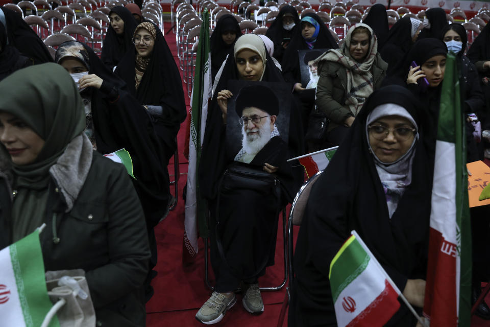 An Iranian woman holds a poster of the Supreme Leader Ayatollah Ali Khamenei during an election campaign rally ahead of the March 1, parliamentary and Assembly of Experts elections, in Tehran, Iran, Tuesday, Feb. 27, 2024. Iran is holding parliamentary elections this Friday, yet the real question may not be who gets elected but how many people actually turn out to vote. Separately, Iranians will also vote on Friday for members of the country's 88-seat Assembly of Experts, an eight-year term on a panel that will appoint the country's next supreme leader after Khamenei, 84. (AP Photo/Vahid Salemi)